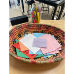 Picture of multicolored woven basket filled with thank you letters from gratitude lesson.