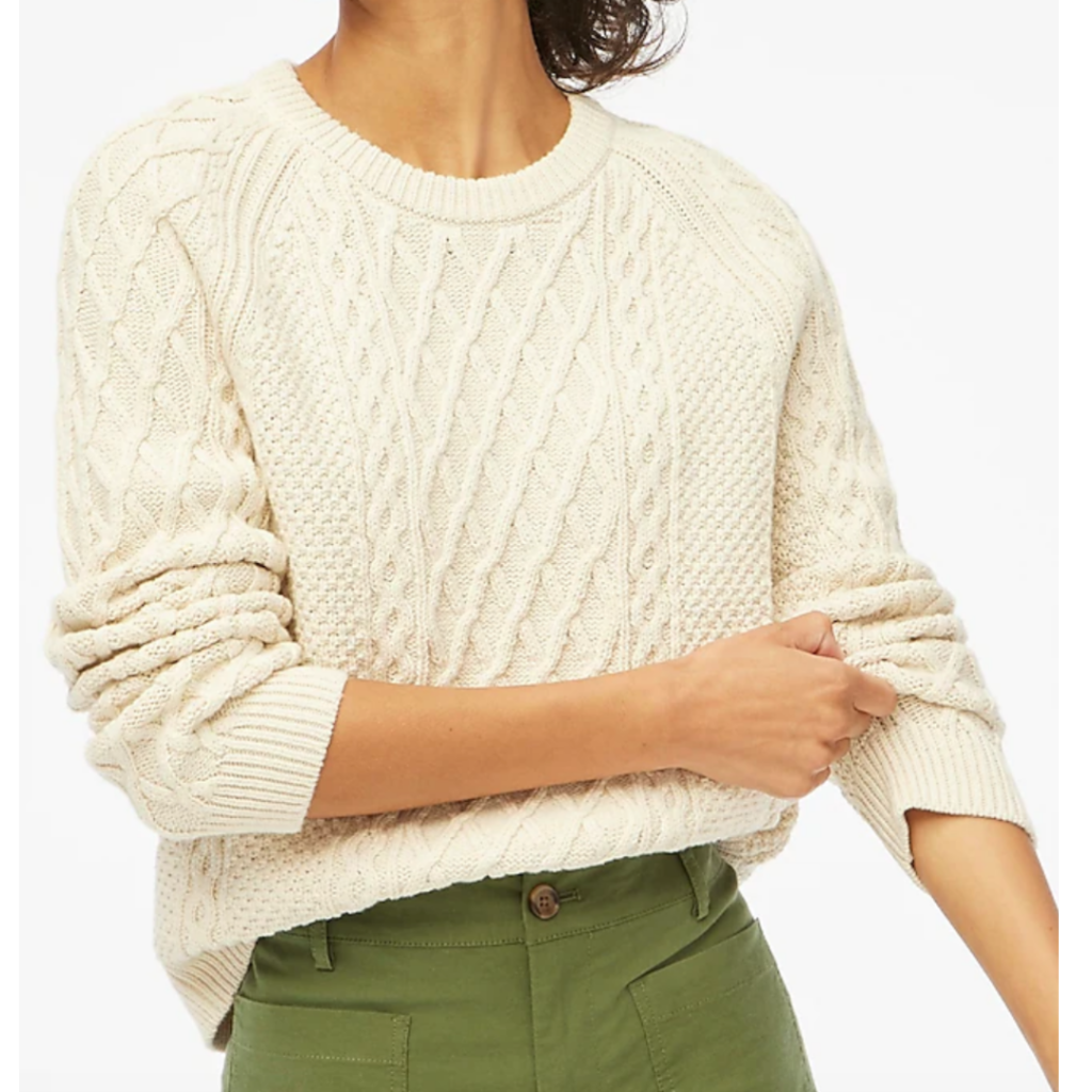 Women in cream cable knit sweater with green pants. Link is included to click and purchase.