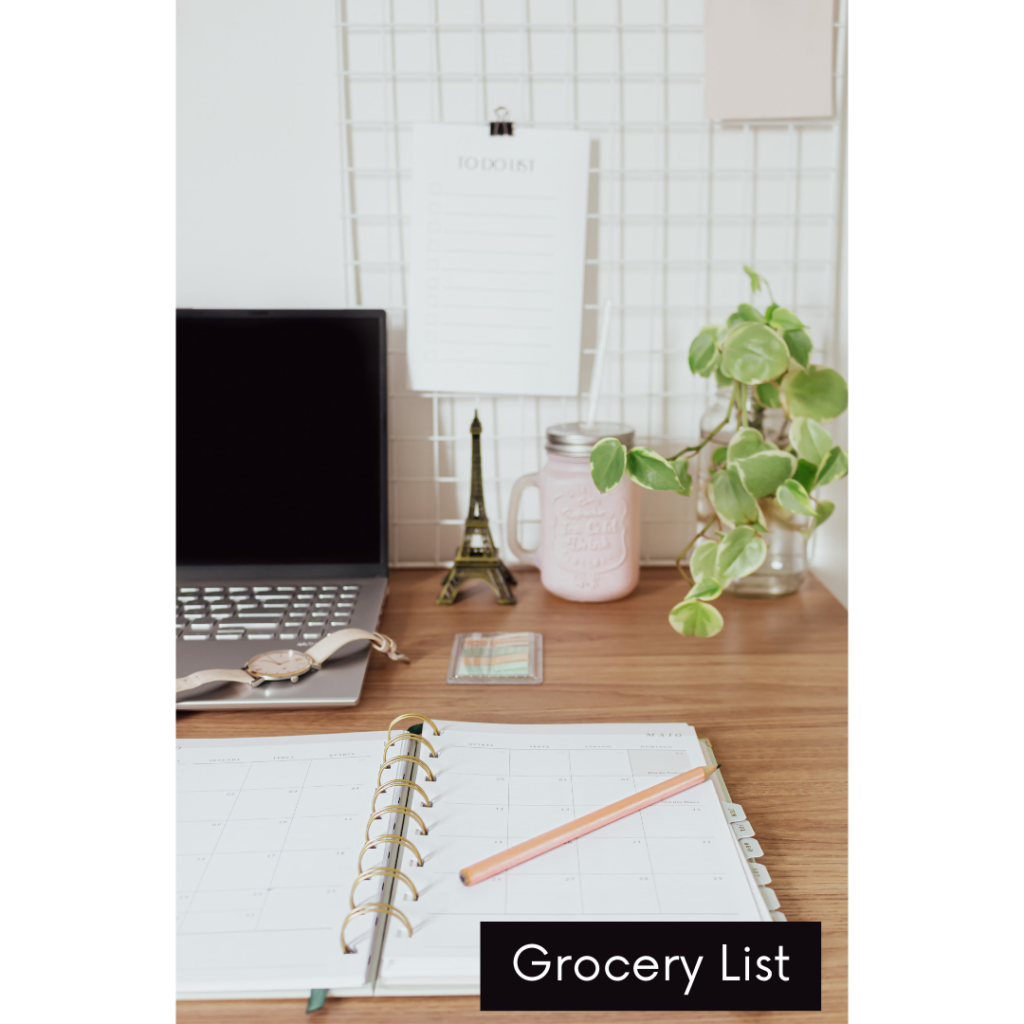 Image of desk with computer, lamp, Eiffel tower, and planner on it. Says "grocery list".