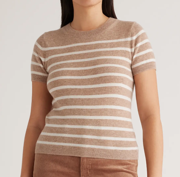 Woman in short sleeve cashmere sweater that is tan with white stripes. Link included for purchase.