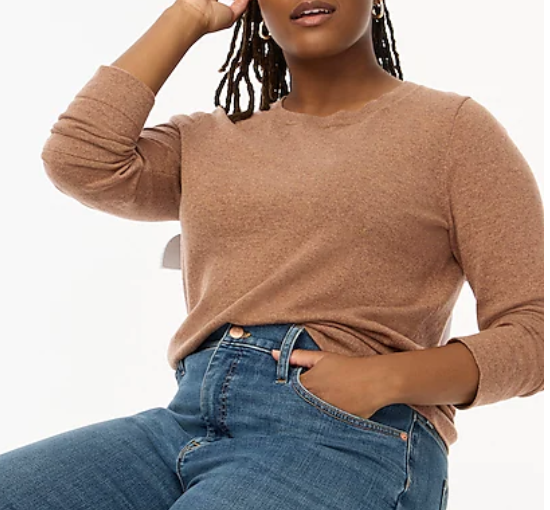 Woman in tan sweater with jeans and hand in pocket. Link included for purchase.