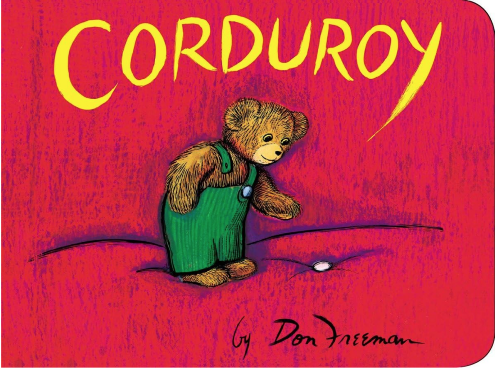 Image of toddler book cover called "Corduroy". Book cover is mostly red with a bear in green overalls reaching for a button.