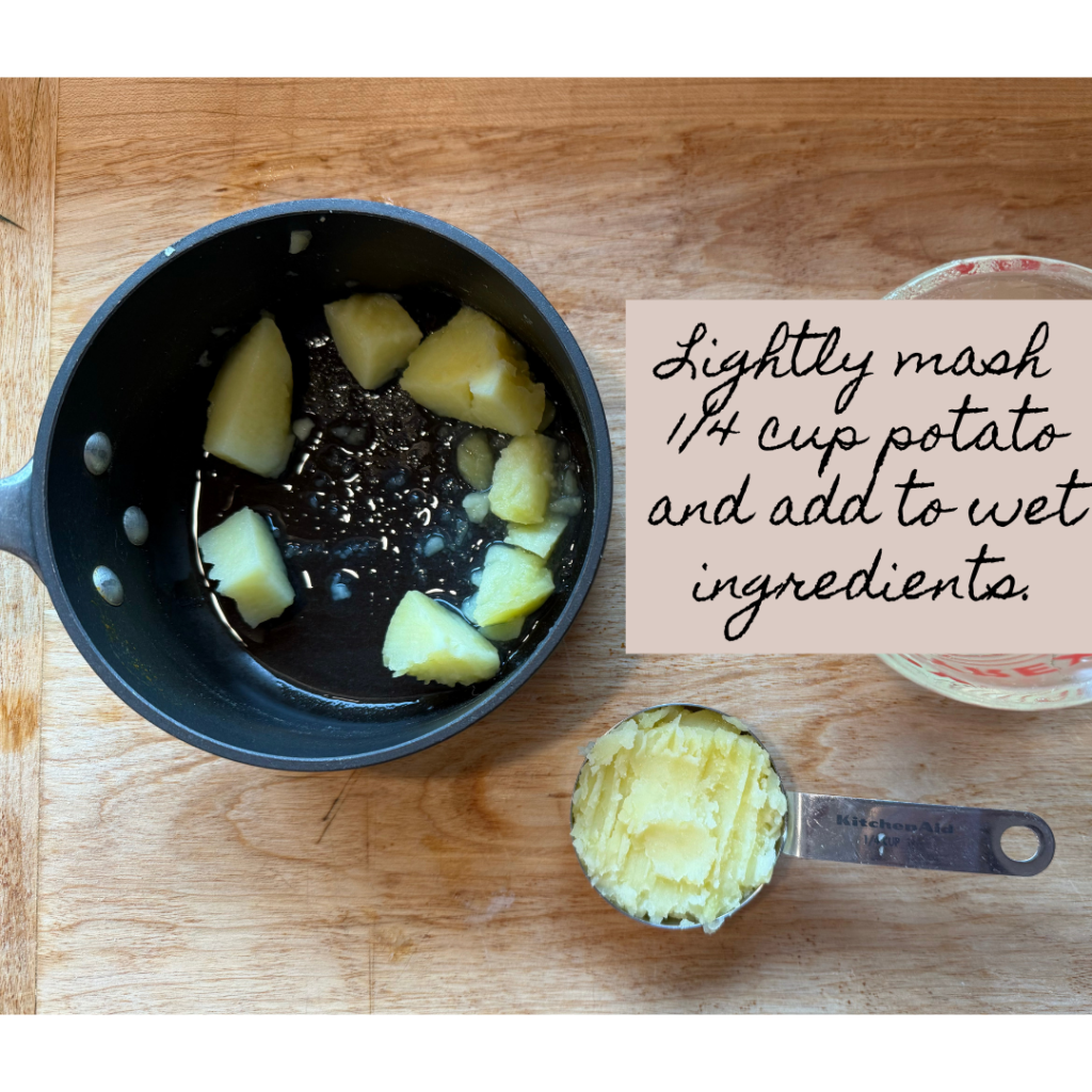 Image of small sauce pan with potato and mashed potato in 1/4 measuring cup. Items are on a wooden cutting board. Text says "lightly mash 1/4 cup potato and add to wet ingredients." 