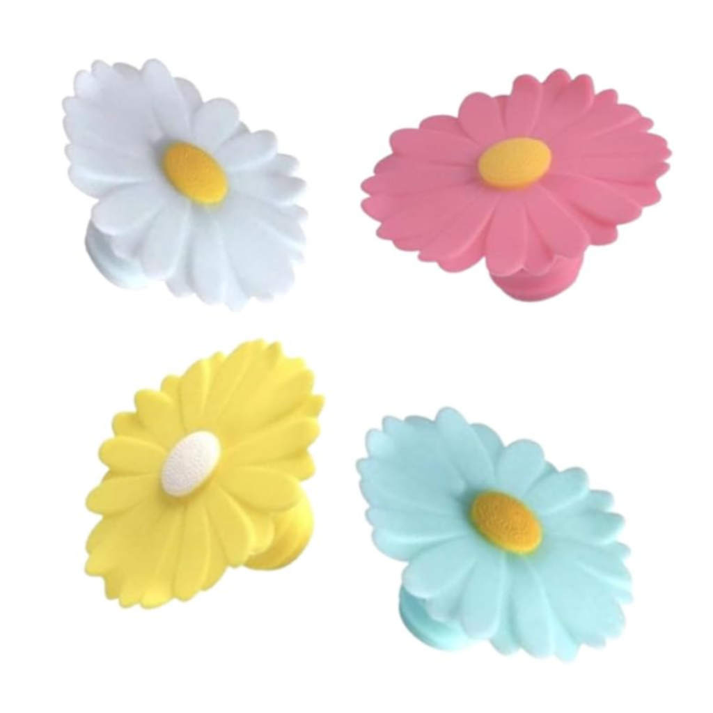 Image of silicone daisy bottle stoppers in white, pink, yellow, and blue as a gift idea. Link below for purchase.