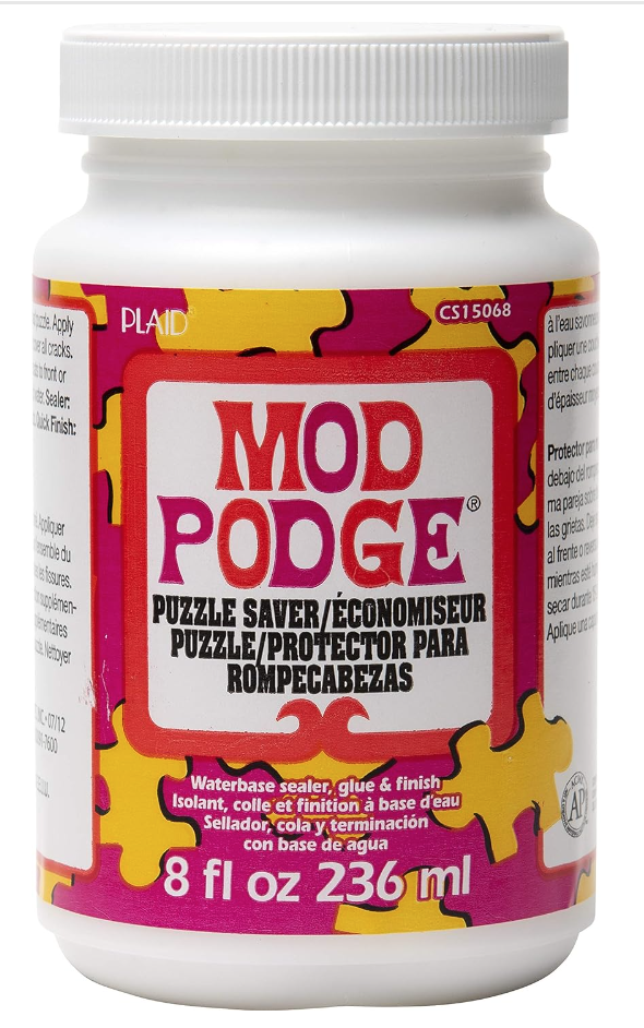 Image of Mod Podge Puzzle Saver in white bottle with pink and yellow label. Link is provided for purchase.