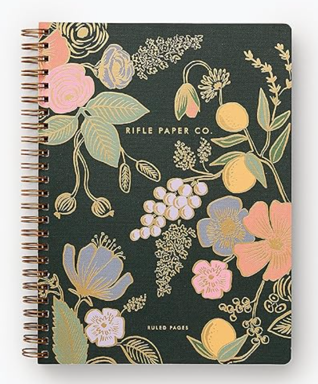 Image of spiral notebook with floral pattern and dark green background.