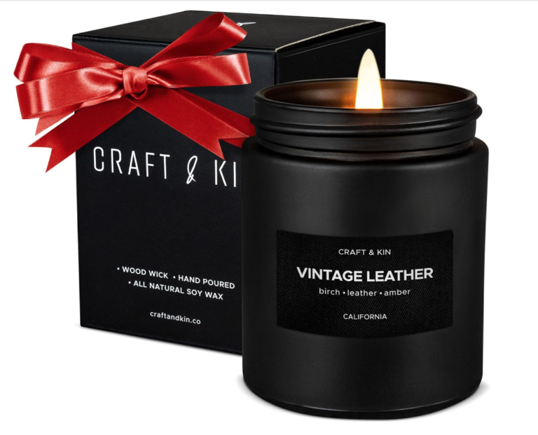 Image of candle in black container with label that says "vintage leather". 