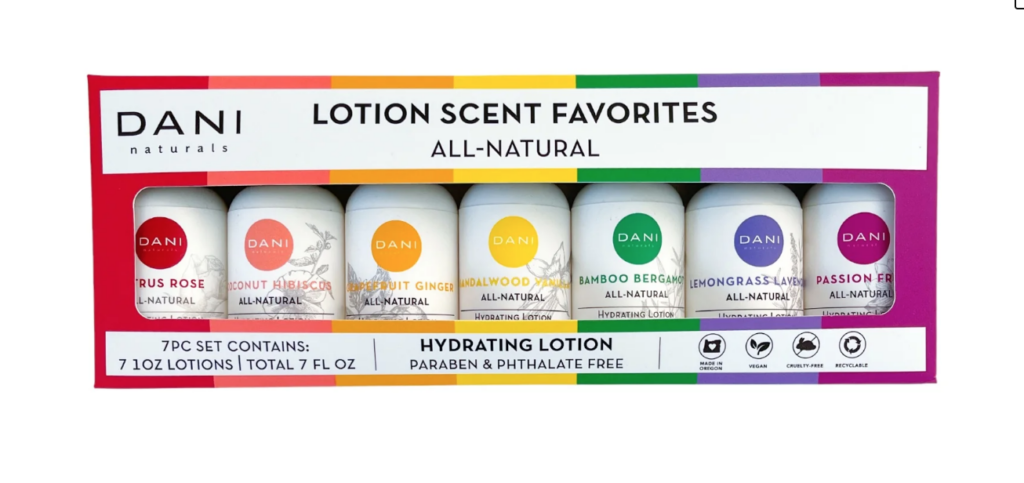 Image of box of lotions. Label says "DANI naturals". And box has 7 travel sized bottles of lotion in a variety of scents. Bottles of lotion are the colors of the rainbow.