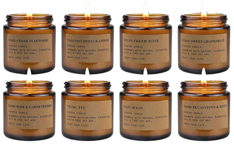 Image of 8 lit candles in amber jars with brown labels as gift idea. Link below for purchase.