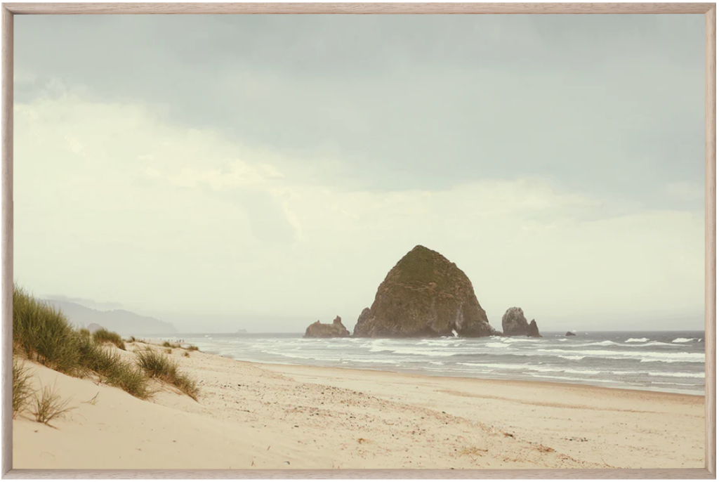 affordable art prints. Image of art print of Cannon Beach, Oregon. There is a picture of a sandy beach, ocean waters, and a large haystack-shaped rock.