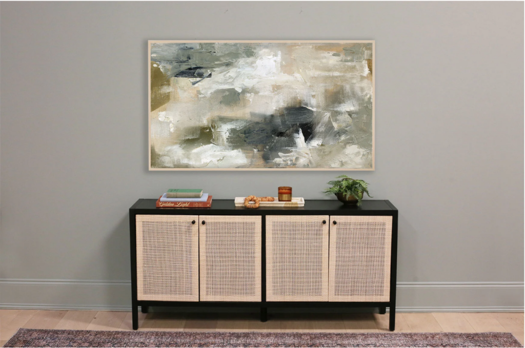 art for tv screen. Image of abstract art with brush strokes in green, blue, tan, and white on grey-green wall over black and tan credenza with red  vintage rug in front. 