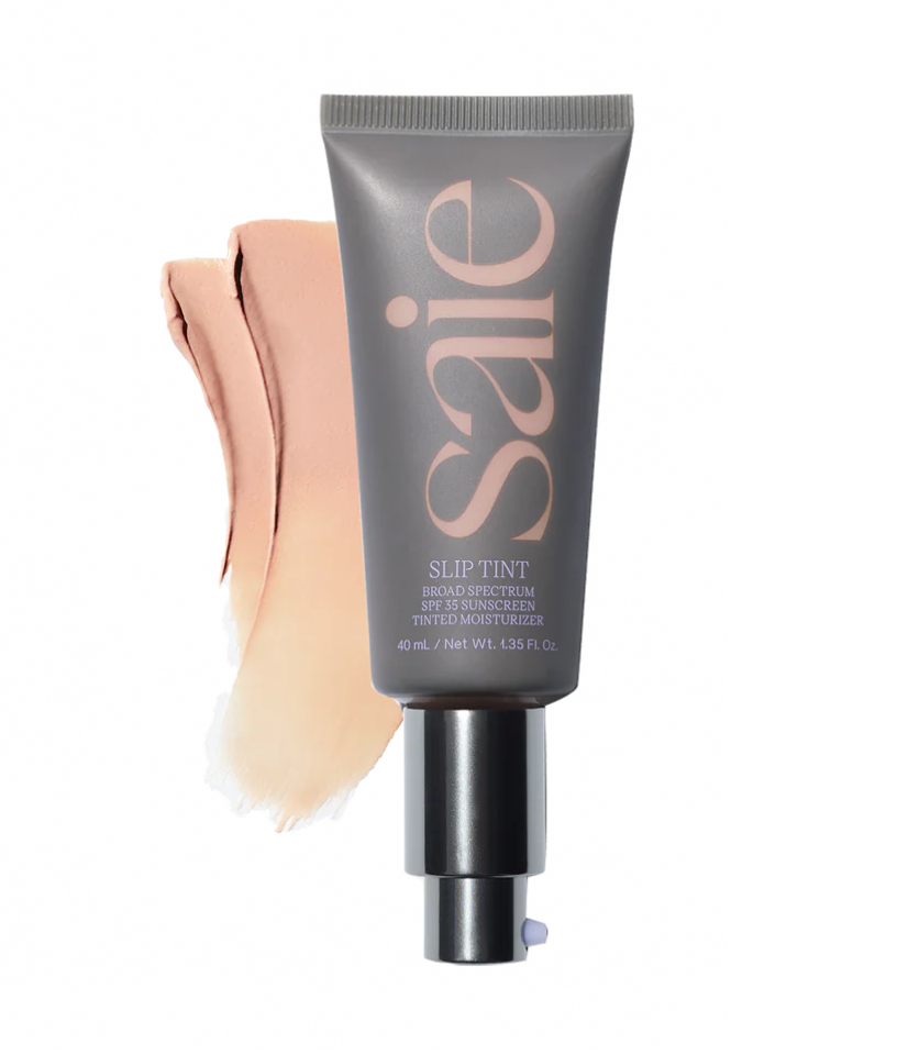 best skin care products. Image of Saie slip tint tinted moisturizer in grey tube with brush strokes of moisturizer. 