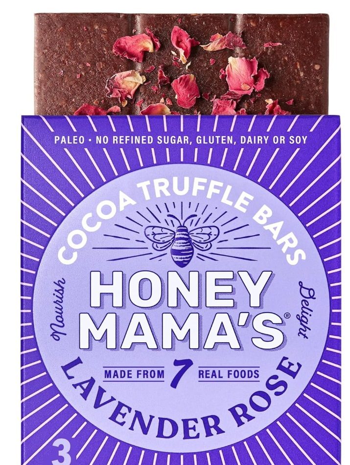 household essentials gift basket. Image of Honey Mama's cocoa truffle bars. Label is purple and flavor is lavender rose. Image also shows part of the chocolate bar with rose pedals.