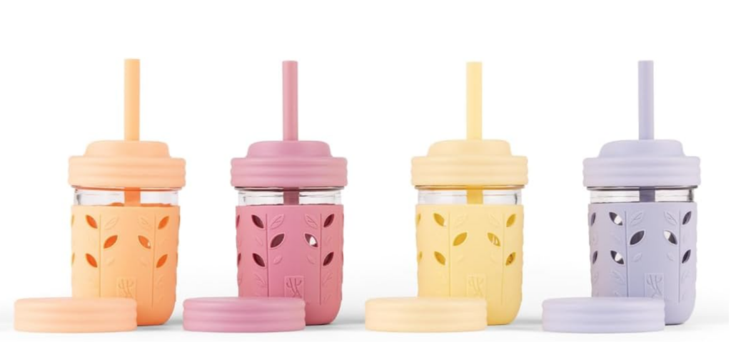 household hacks. Image of 4 glass sippy cups with straws and with silicone covers in pastel orange, red, yellow, and purple.