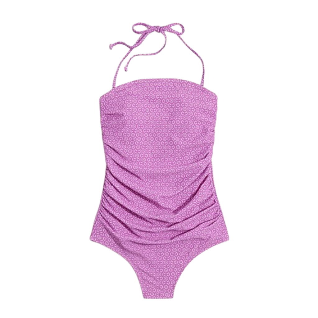 Women's swimsuits. Image of purple one piece with pattern and strap that goes around neck. 