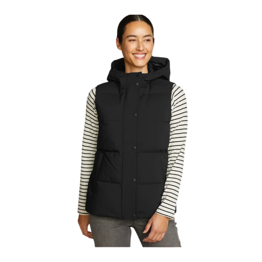 jackets for workwear. Woman in black vest with hood and black and white striped stirt.