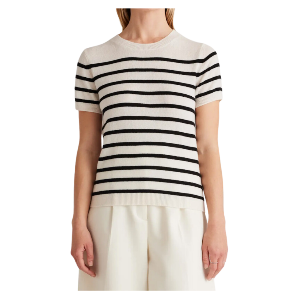 stylish teacher outfits. Image of woman wearing black and white striped short sleeve shirt and white trousers. 