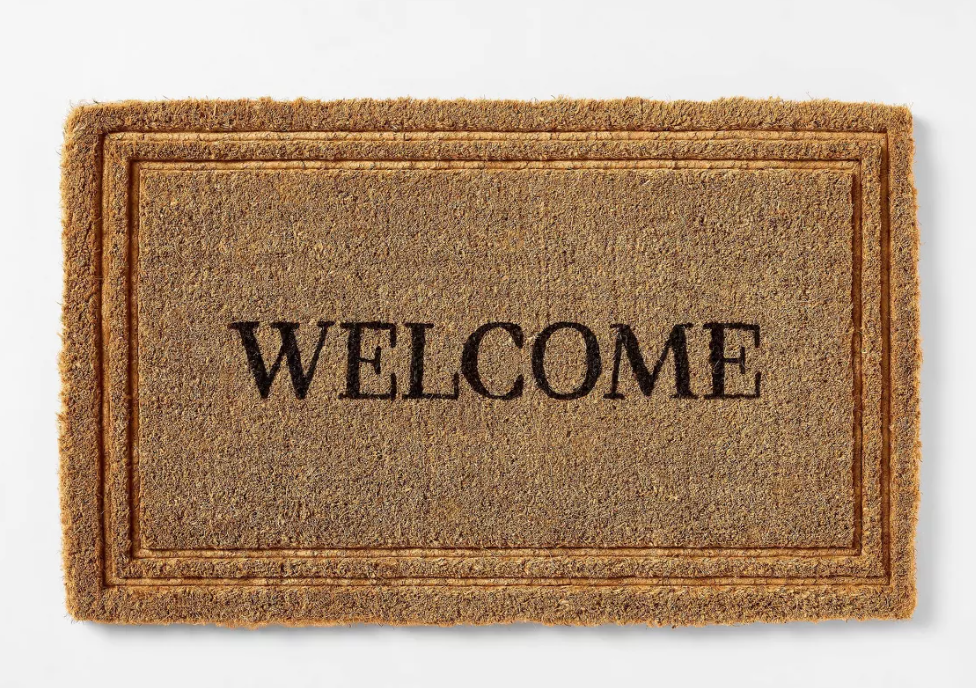 welcome mat front door. Image of embossed welcome mat that says "welcome" in black letters with neutral boarder. 